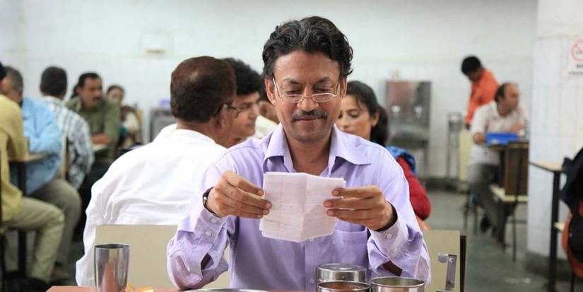 Irrfan Khan reading something written on a paper in The Lunchbox