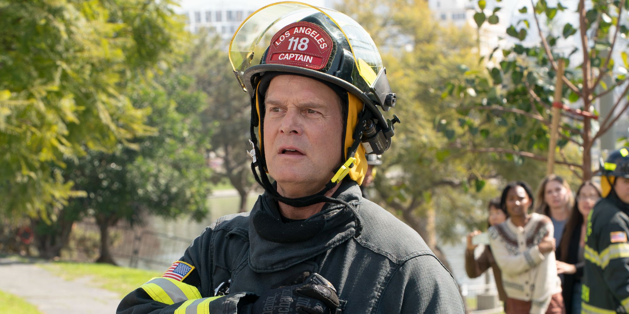 Peter Krause in full 118 gear in a park in 9-1-1