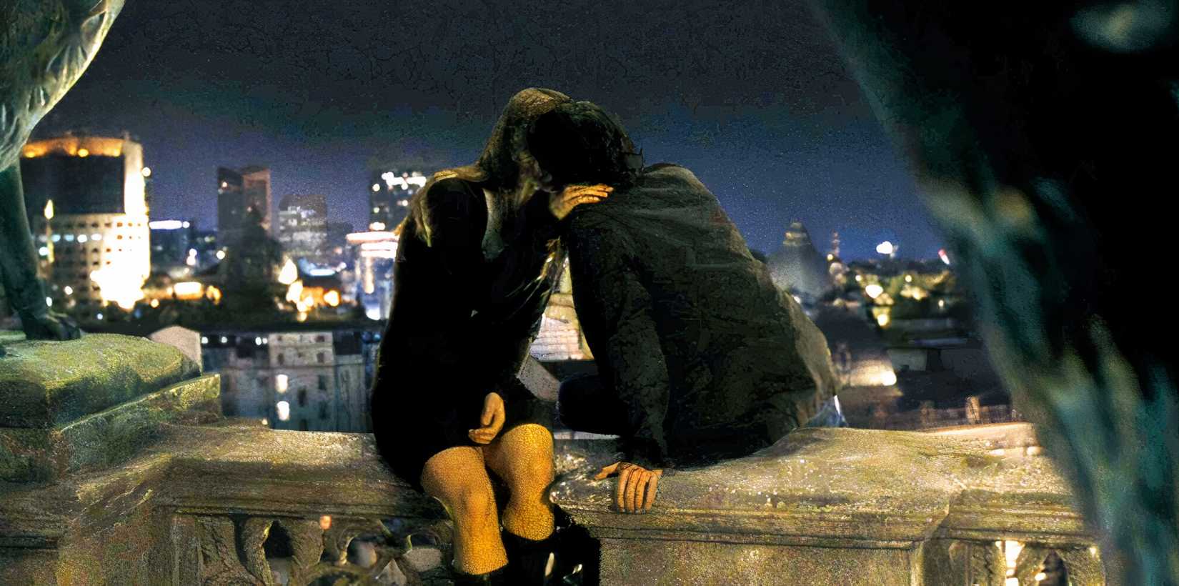 Vivian and Aiden kiss in Bucharest, Romania, overlooking the city