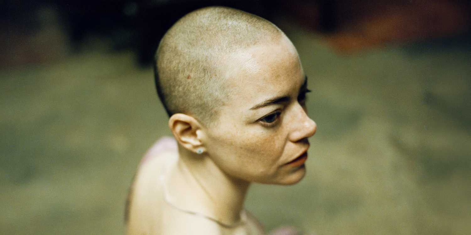 A bald Emma Stone as seen from above in Bugonia
