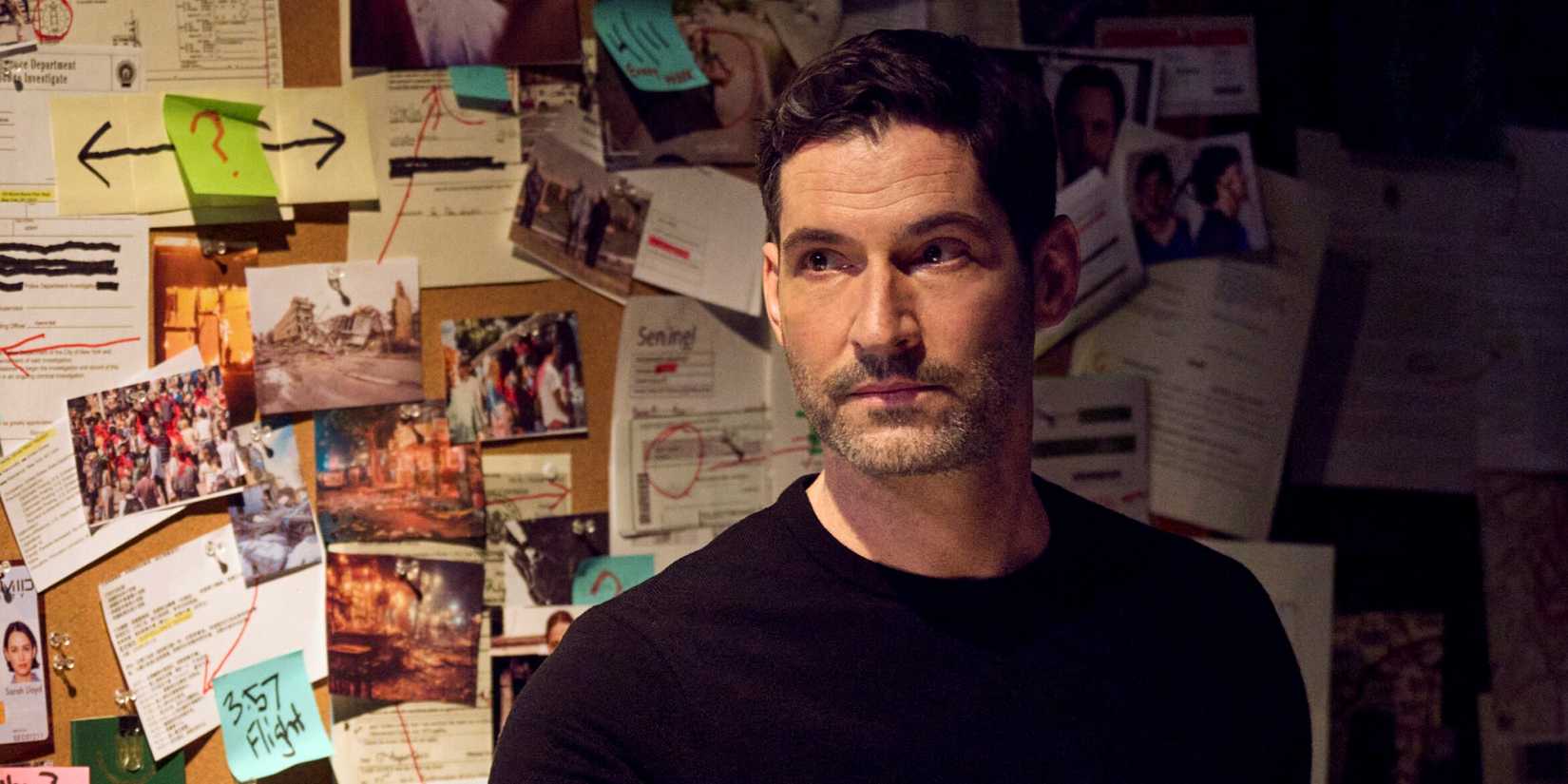 Tom Ellis as CIA Agent Colin Glass standing in front of a case board in the CBS series CIA