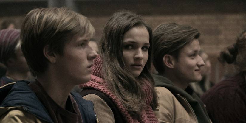 Louis Hofmann as Jonas and Lisa Vicari as Martha and Paul Lux and Bartosz in Dark.