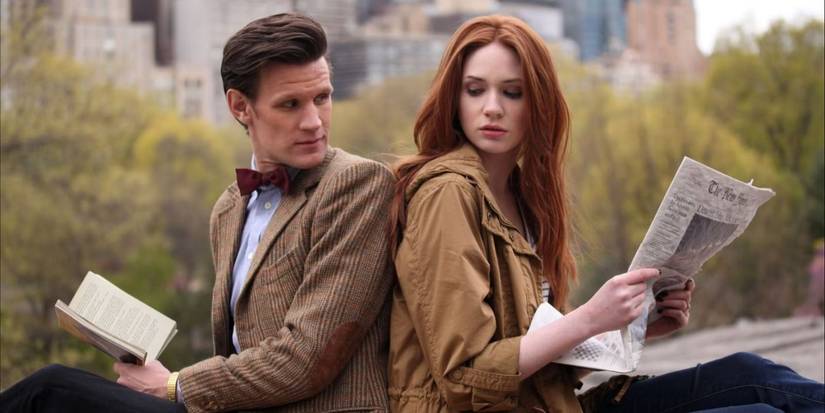 Matt Smith and Karen Gillan sitting back-to-back in 'Doctor Who'