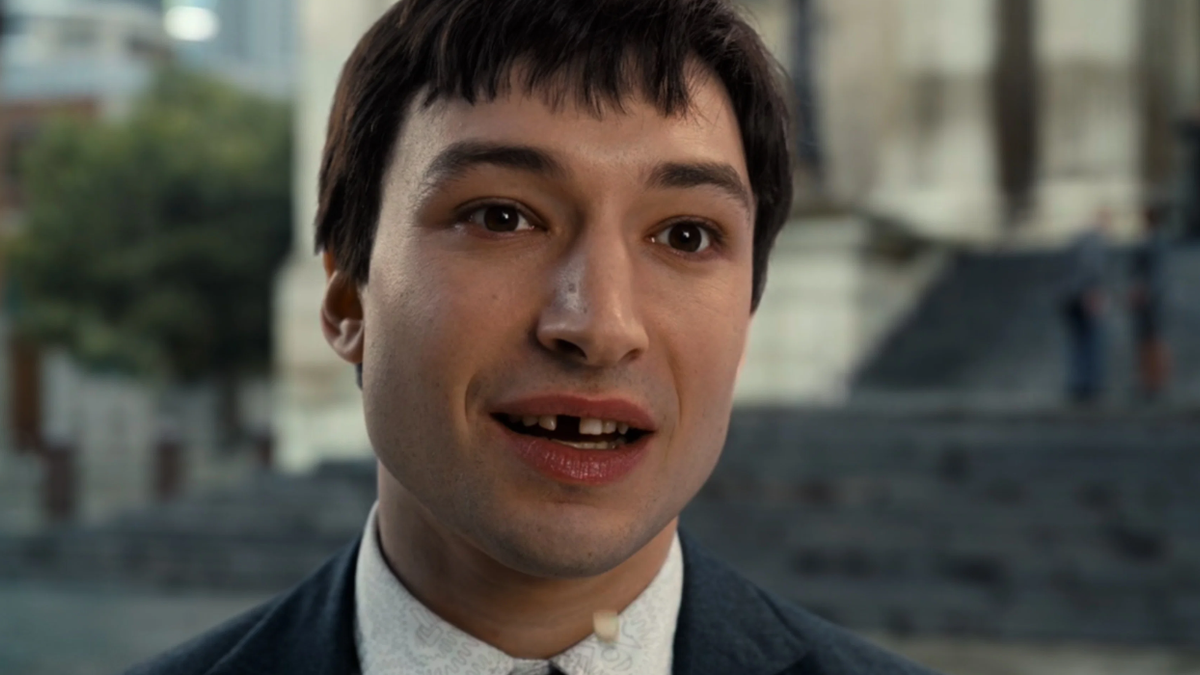 Barry Allen missing some teeth and looking ahead with a blank stare