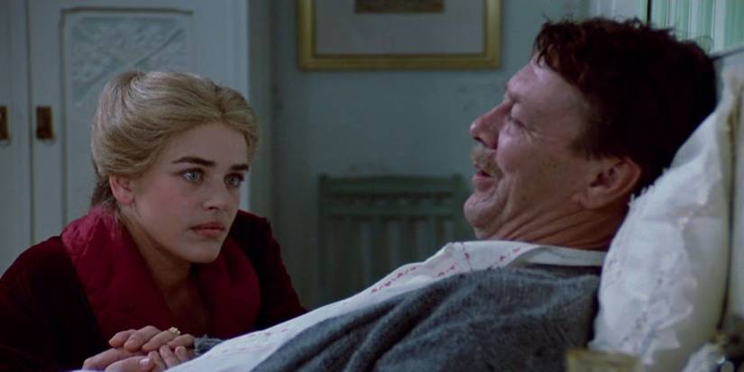 A man in bed with a woman at his bedside in the TV miniseries 'Fanny and Alexander'