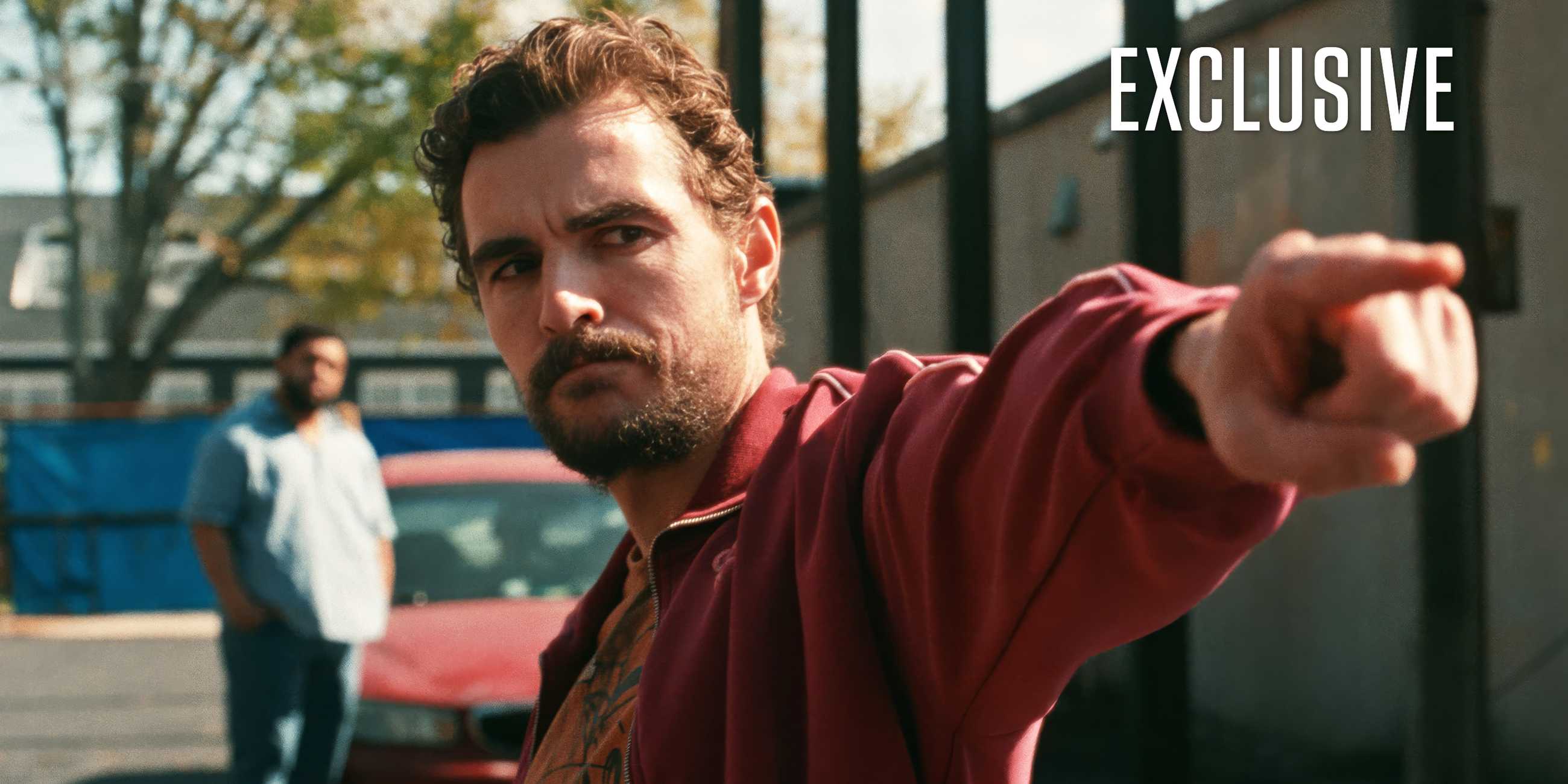 Dave Franco pointing to someone off-camera in an exclusive image for Idiots