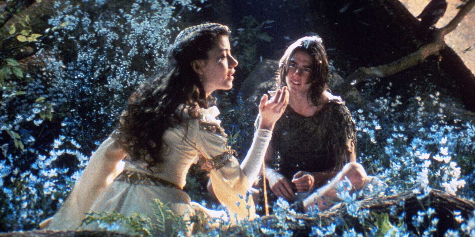 Mia Sara and Tom Cruise in a meadow in Legend
