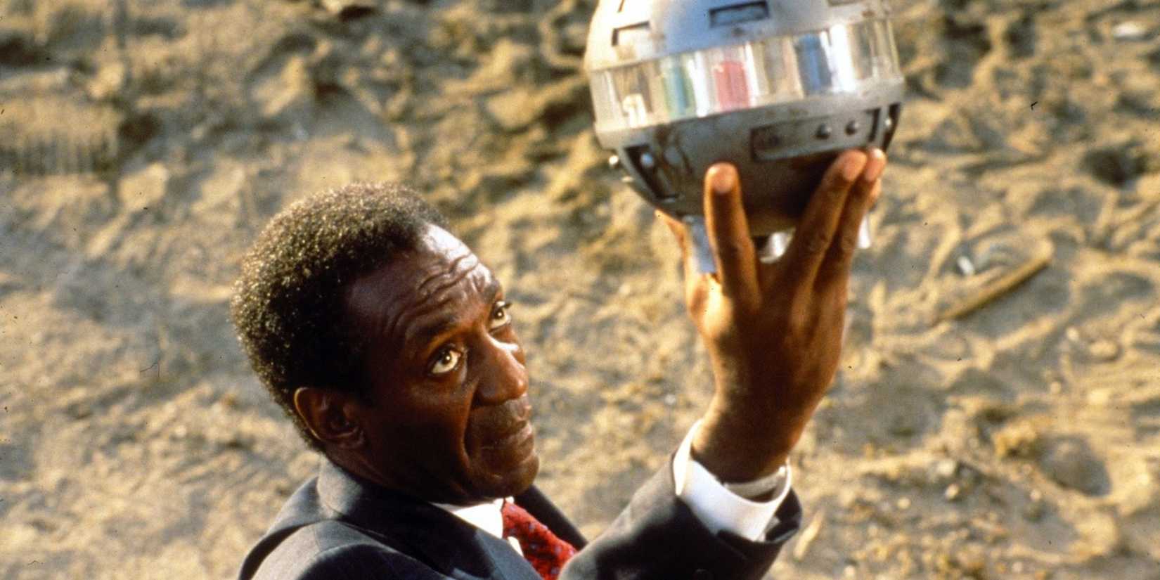 Leonard holds up a metal ball