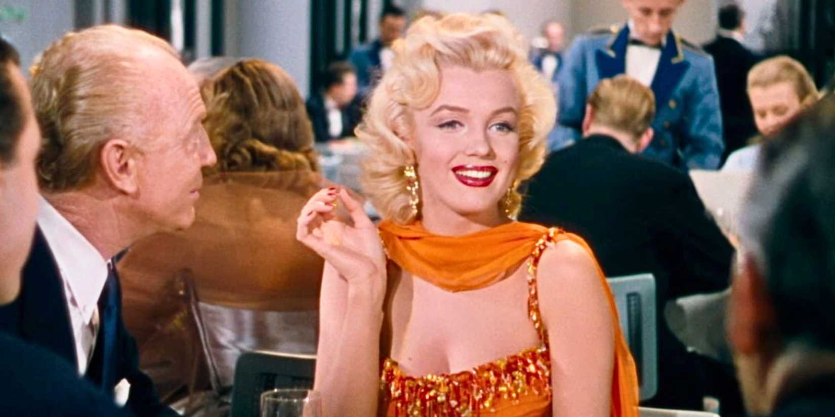 Marilyn Monroe sitting at a table with several men in Gentlemen Prefer Blondes (1953)-1