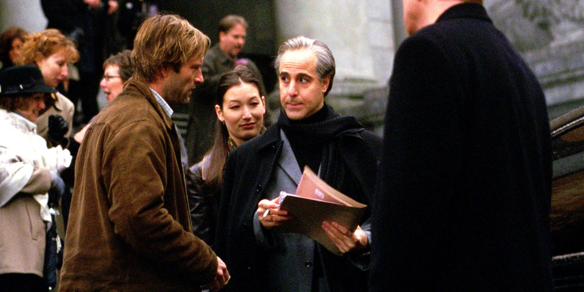 Aaron Eckhart talks to Stanley Tucci outside with paperwork in The Core