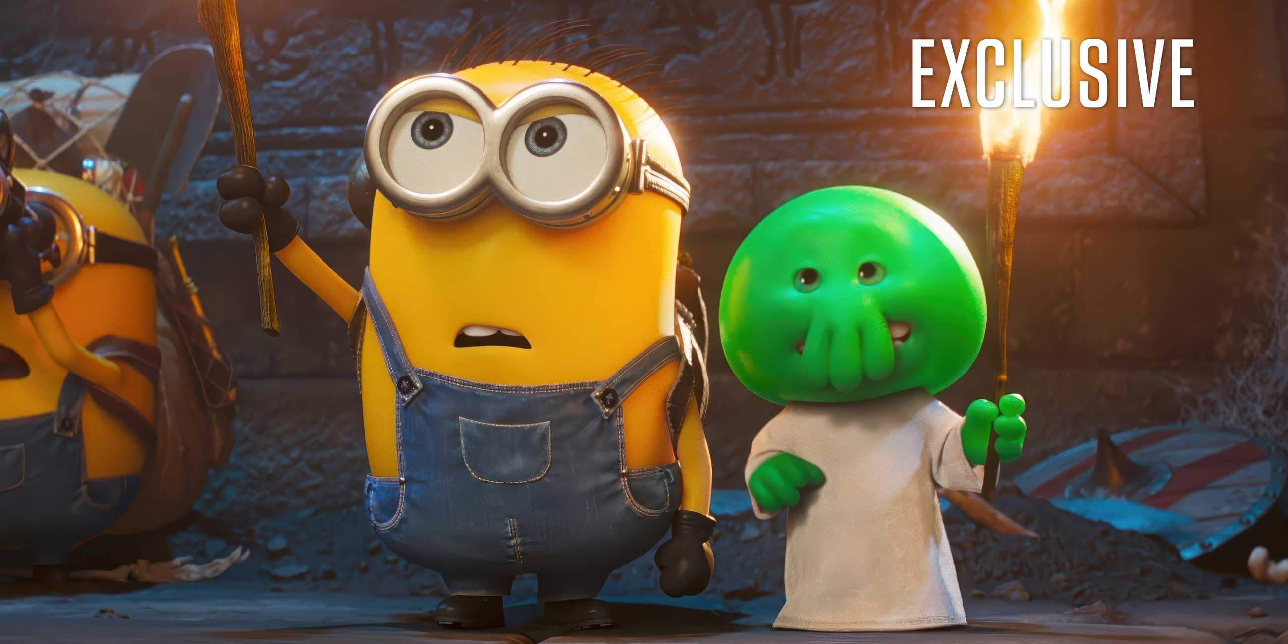 A minion standing next to a little green monster in an exclusive image for Minions-&-Monsters
