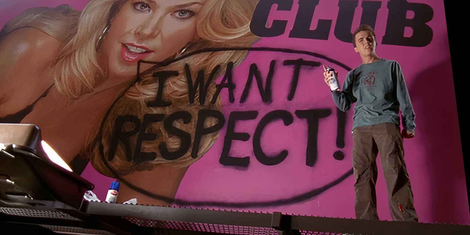 Frankie Muniz as Malcolm standing in front of a billboard for a strip club with graffiti on it in 'Malcolm in the Middle'