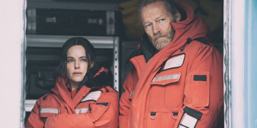 Magnus (Iain Glen) and Rose (Emily Hampshire) looking at something offscreen in 'The Rig'
