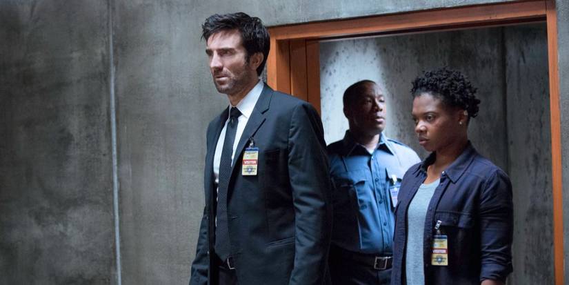 Sharlto Copley and Susan Heyward with a guard behind them in 'Powers'