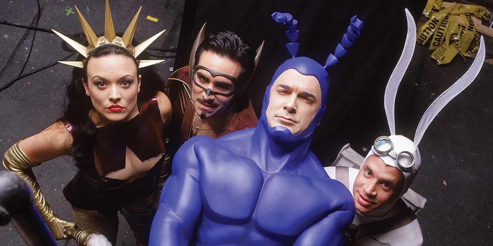 Promotional image of the cast of The Tick (2001) looking up.