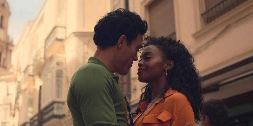 Alex Hassell and Nafessa Williams hugging and gazing at each other on the streets in Rivals Season 1