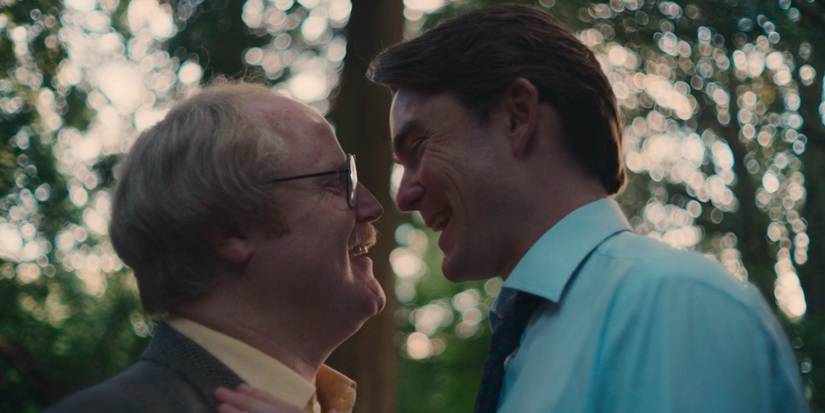 Gary Lamont and Hubert Burton smiling at each other and going in for a kiss in Rivals Season 1