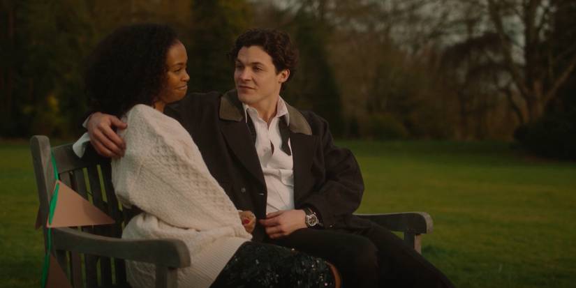 Nafessa Williams and Gabriel Tierney on a bench at dawn, talking in Rivals Season 1