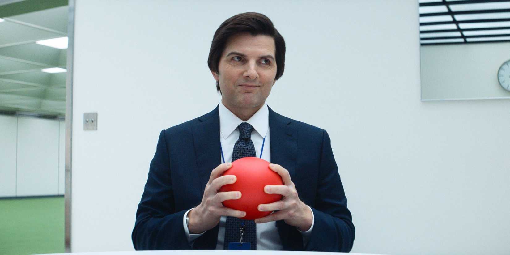 Adam Scott holding a ball in Severance.