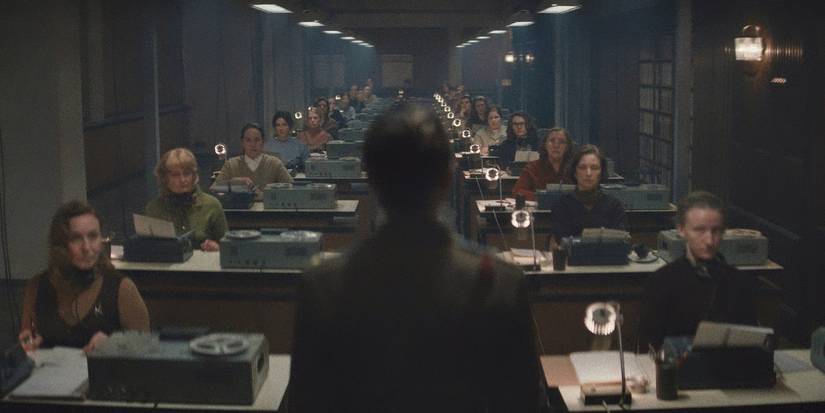 Anna Maxwell Martin standing in front of the KGB surveillance department in Star City
