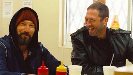 Jon Bernthal as Mikey sitting at a food counter next to Ebon Moss-Bachrach as Richie in
