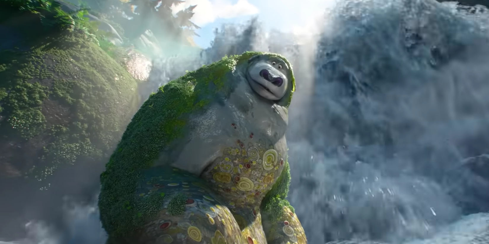 A Rock Bear stands in front of a waterfall