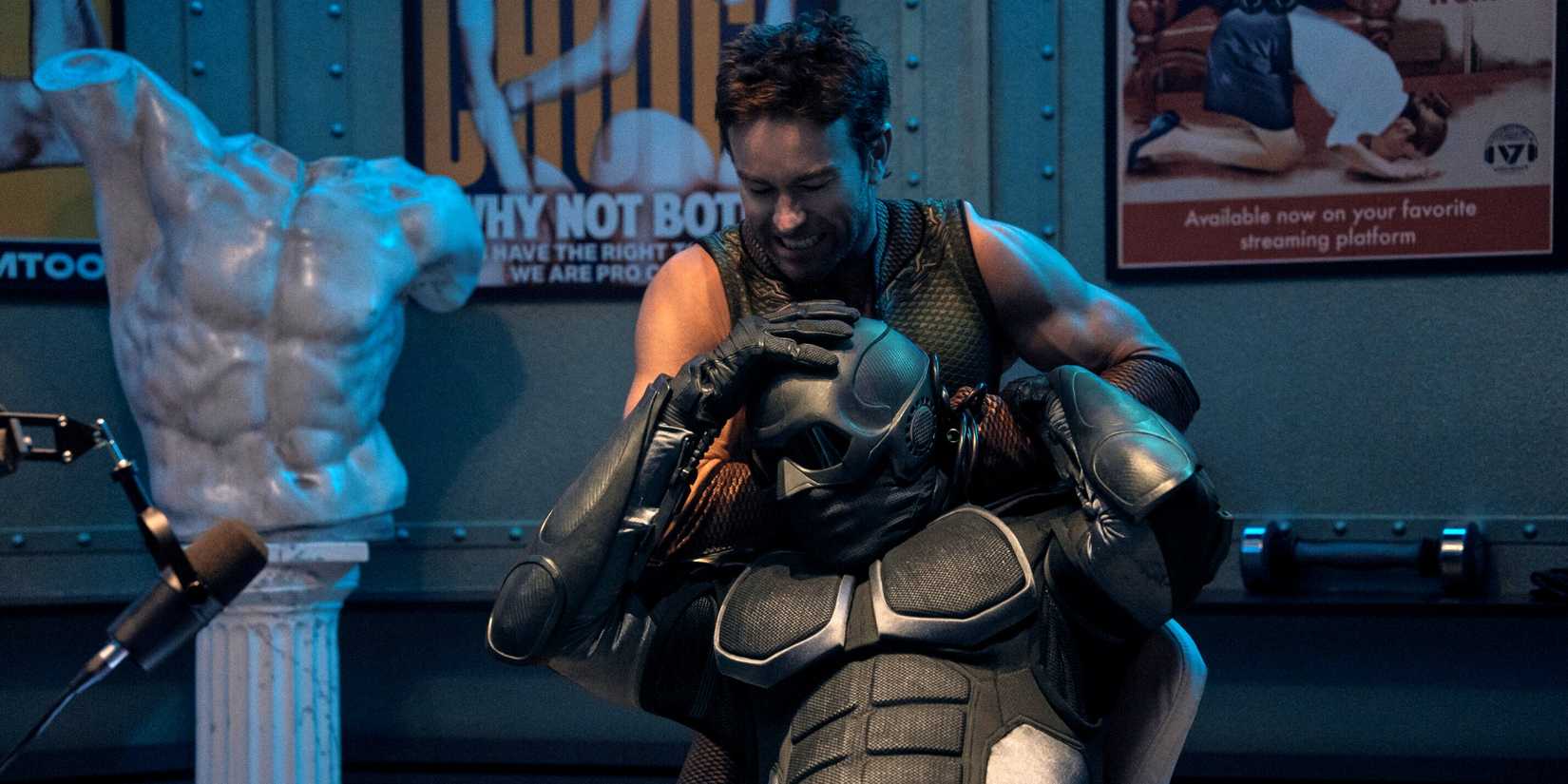 Chace Crawford as The Deep standing behind Nathan Mitchell as Black Noir while strangling him in The Boys