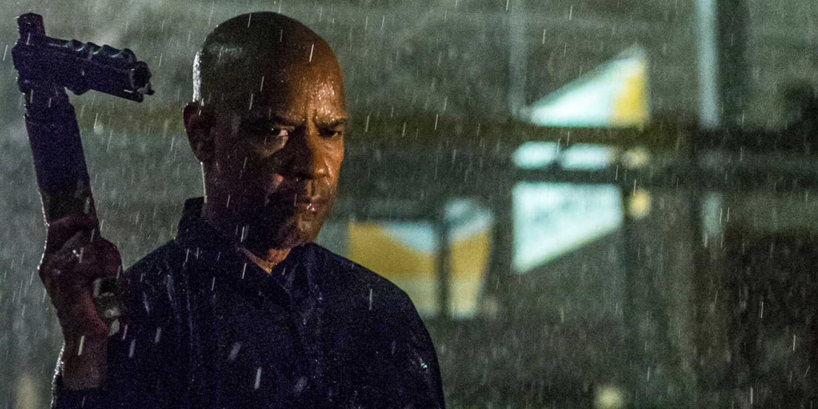 Robert McCall (Denzel Washington) holds a gun in the rain in 'The Equalizer' (2014)