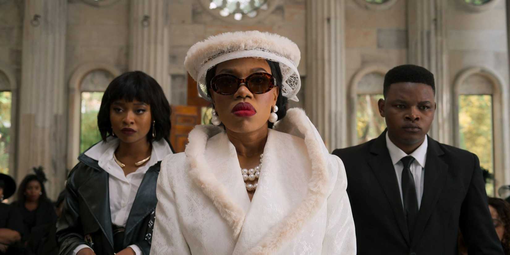 Three characters standing together in the Netflix series 'The Polygamist'
