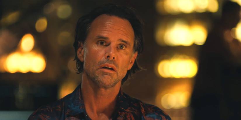 Rick sitting in a bar looking stunned in The White Lotus.