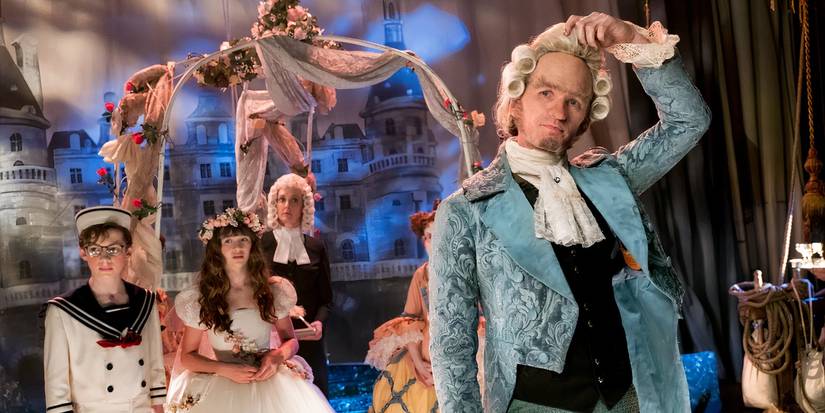 Count Olaf and the Baudelaire children wearing elaborate wedding costumes in A Series of Unfortunate Events