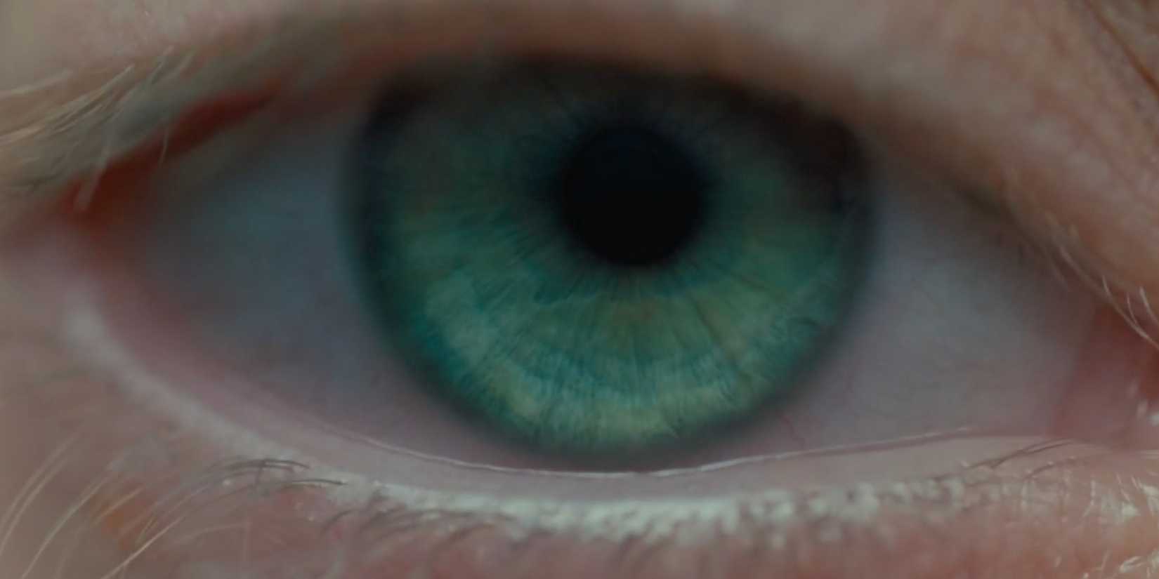 A greenish blue eye shown up close in the opening shot of Blade Runner 2049
