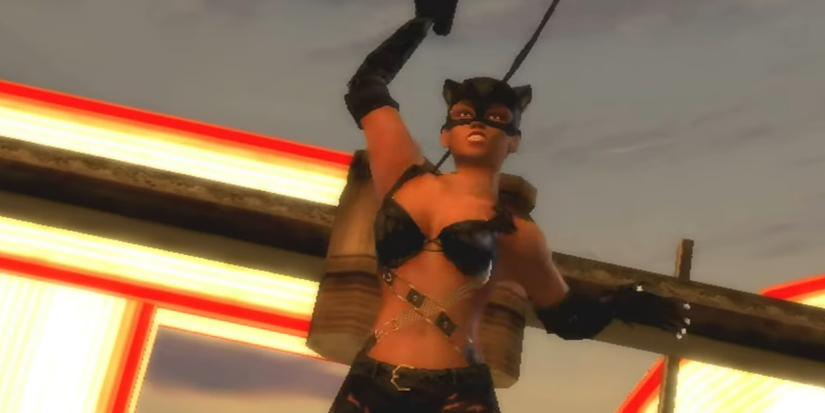 A polygonal version of Halle Berry's Catwoman using her whip on top of a building in the Ps2 version of 'Catwoman'