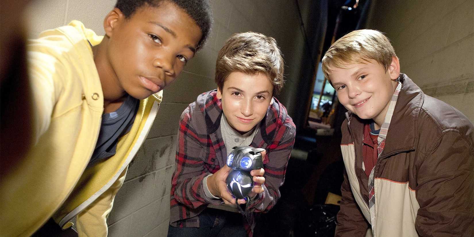 A trio of children holding up an alien to the camera in found footage film 'Earth to Echo'