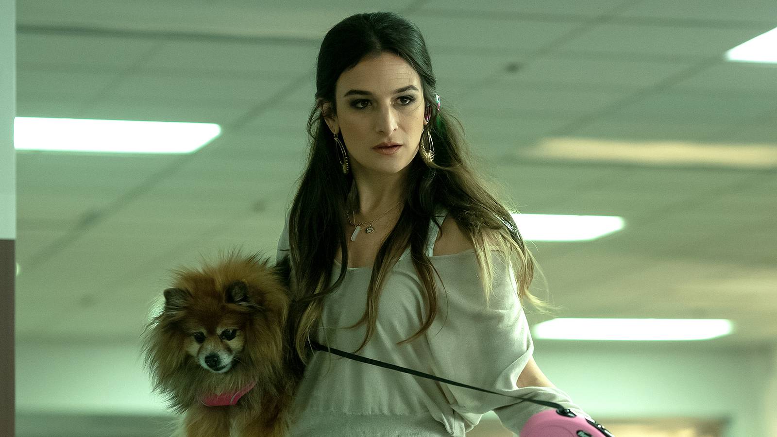Jenny Slate holding a dog under her arm in 'Everything Everywhere All At Once' 