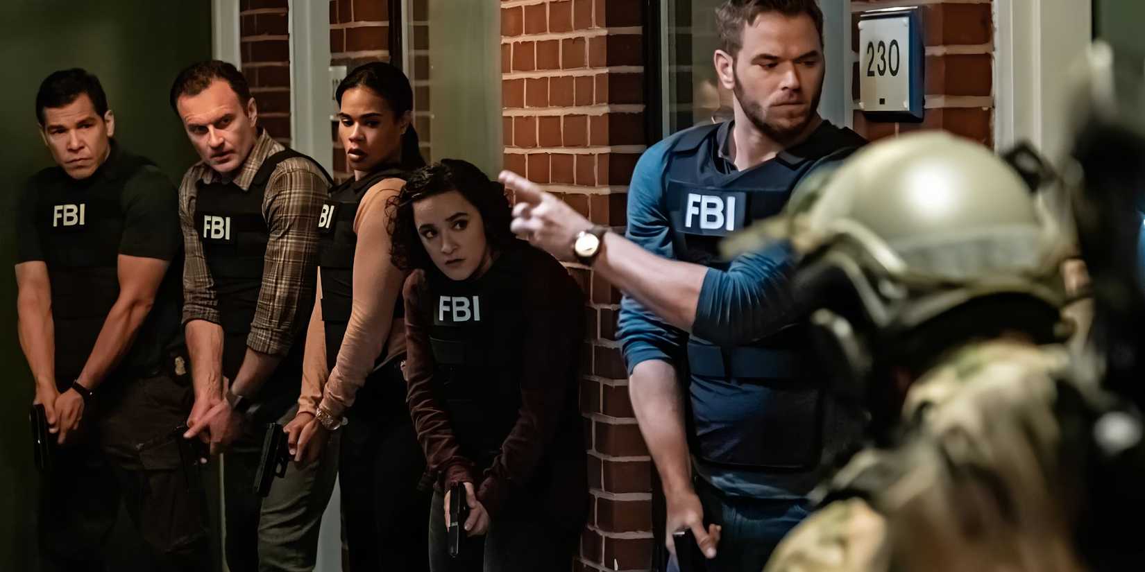 FBI agents stand outside a door with guns drawn in FBI.