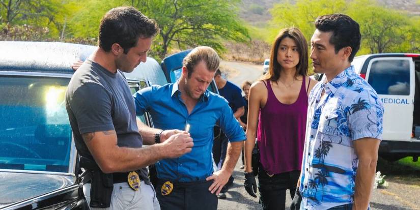 Five-O team standing together as they look at a piece of evidence.