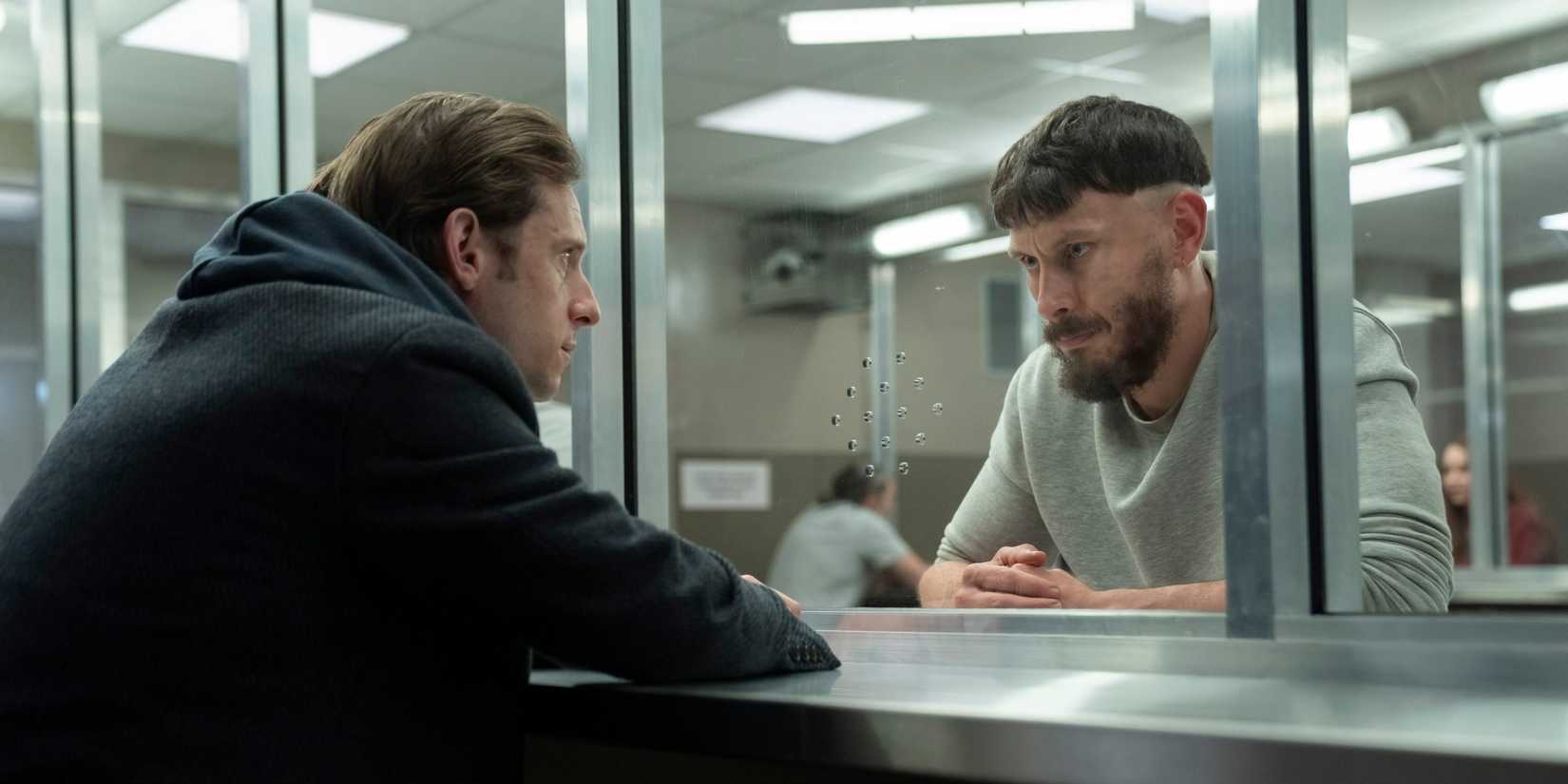 Niall and Ruben talking through a prison visitation glass wall in the Half Man finale