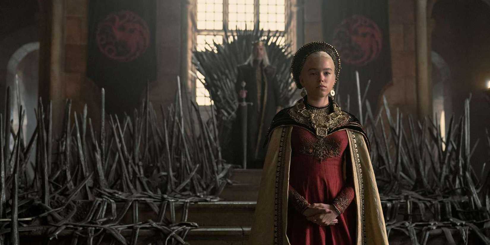 Rhaenyra stands before King Viserys I on the Iron Throne