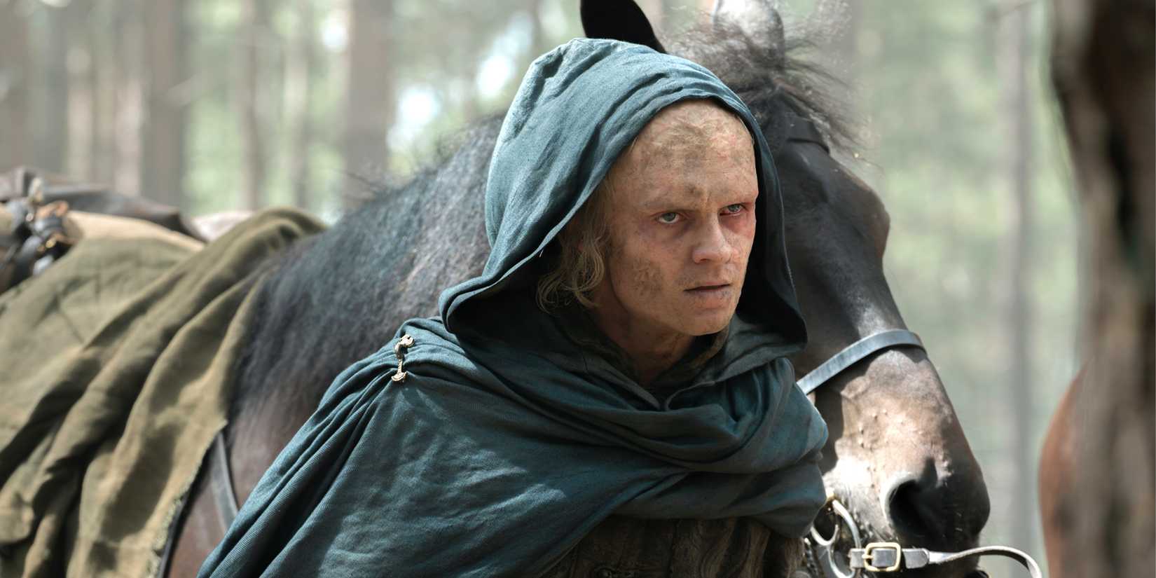 Tom Glynn Carney cloaked walking with a horse in 'House of the Dragon' Season 3 