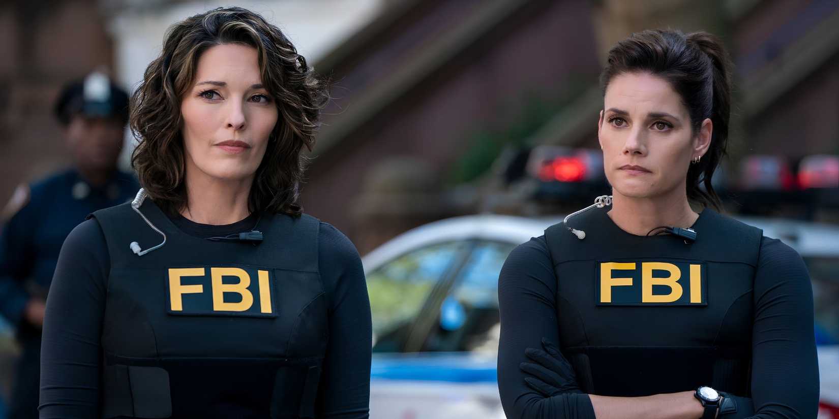 Isobel Castille (Alana de la Garza) and Maggie Bell (Missy Peregrym) standing outside in black FBI gear in FBI.