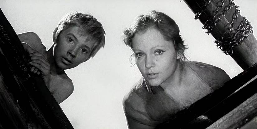 Two characters looking down into a hole in the ground in Ivan's Childhood
