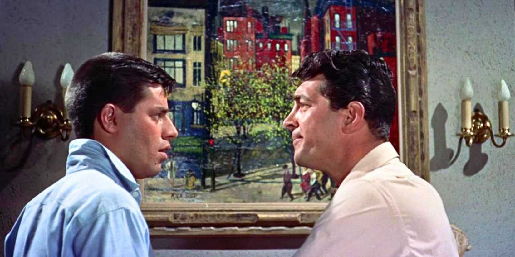 Jerry Lewis looking at Dean Martin standing in front of him in Artists and Models (1955)