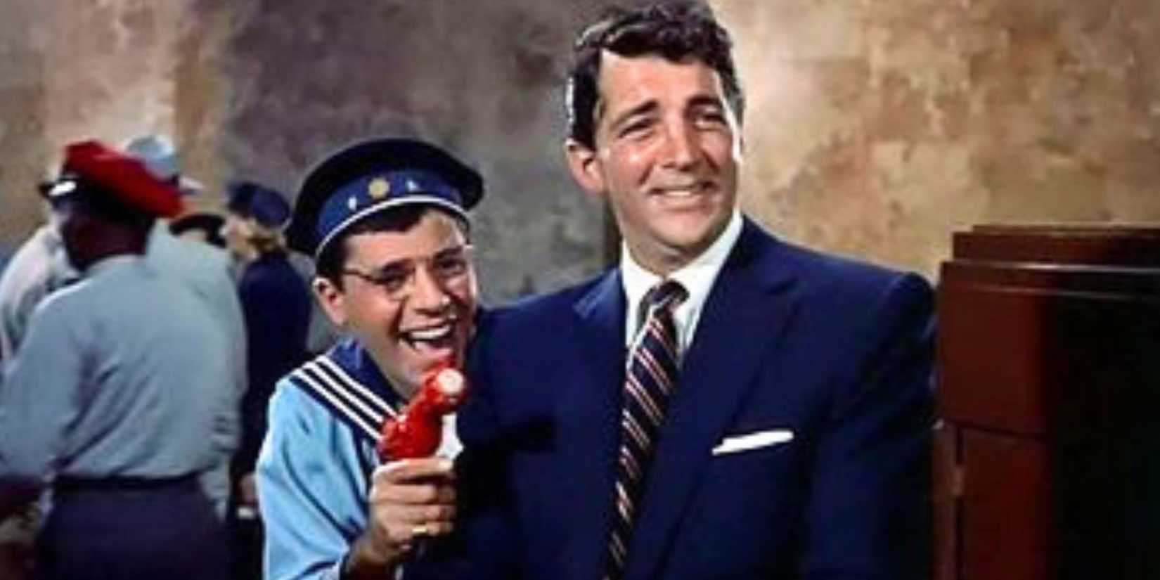 Jerry Lewis standing next to Dean Martin holding a toy gun while both are laughing in You're Never Too Young (1955)