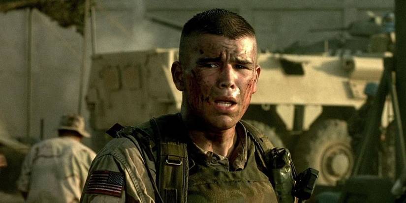 An army sergeant with bloodied face looks distraught as he stands in a military compound in Black Hawk Down.
