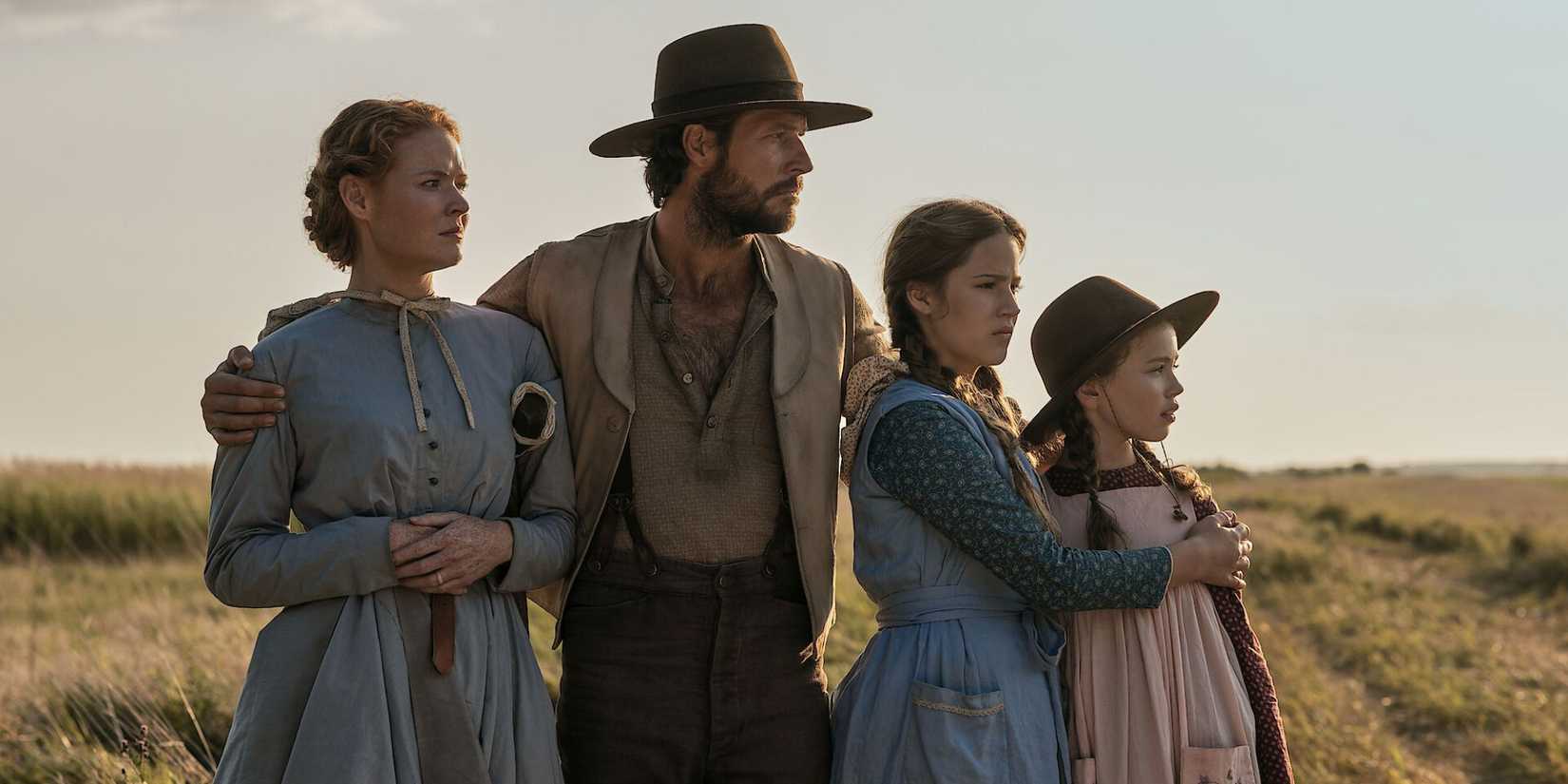 The Ingalls family looking out at something in 'Little House on the Prairie'