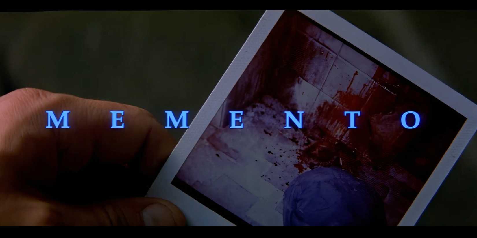 Guy Pearce holding a Polaroid photo in the opening titles of Memento