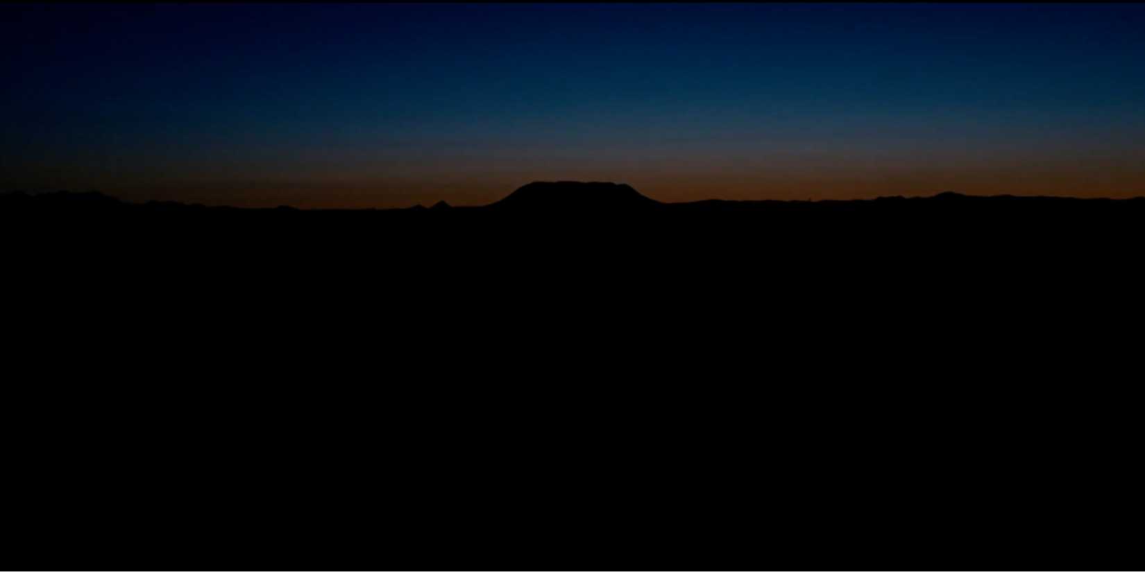 The sunrise above the horizon in the opening shot of No Country for Old Men