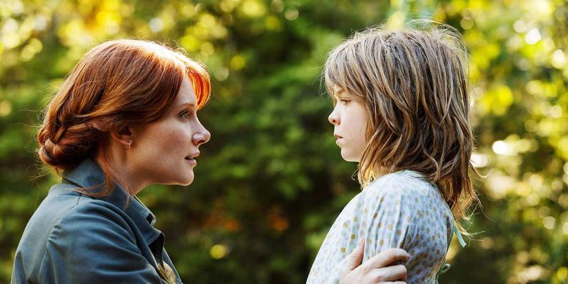Bryce Dallas Howard talks to Oakes Fegley who wears a hospital gown outside in Pete's Dragon