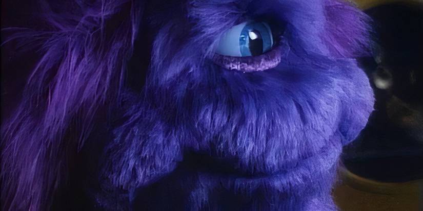 A furry purple creature with one eye smiling in 'Purple People Eater' (1988)
